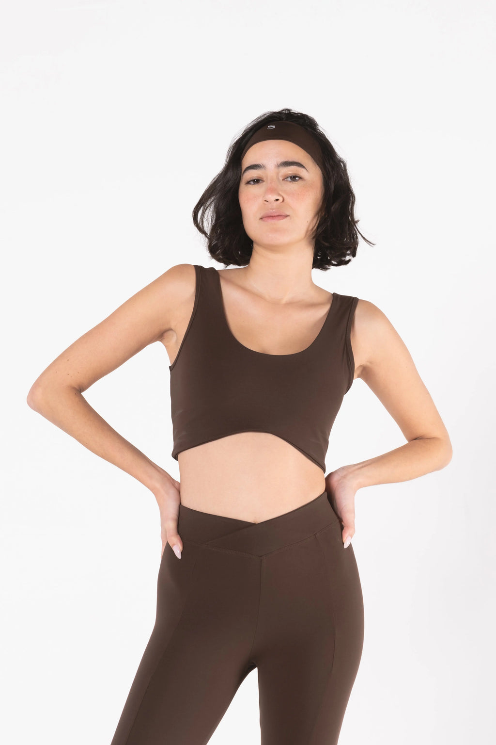 Woman wearing LESS Activewear Flow Sports Bra, designed for fuller busts