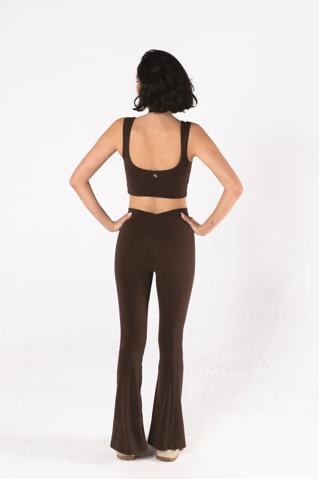 Woman wearing LESS Activewear Flow Sports Bra, designed for fuller busts