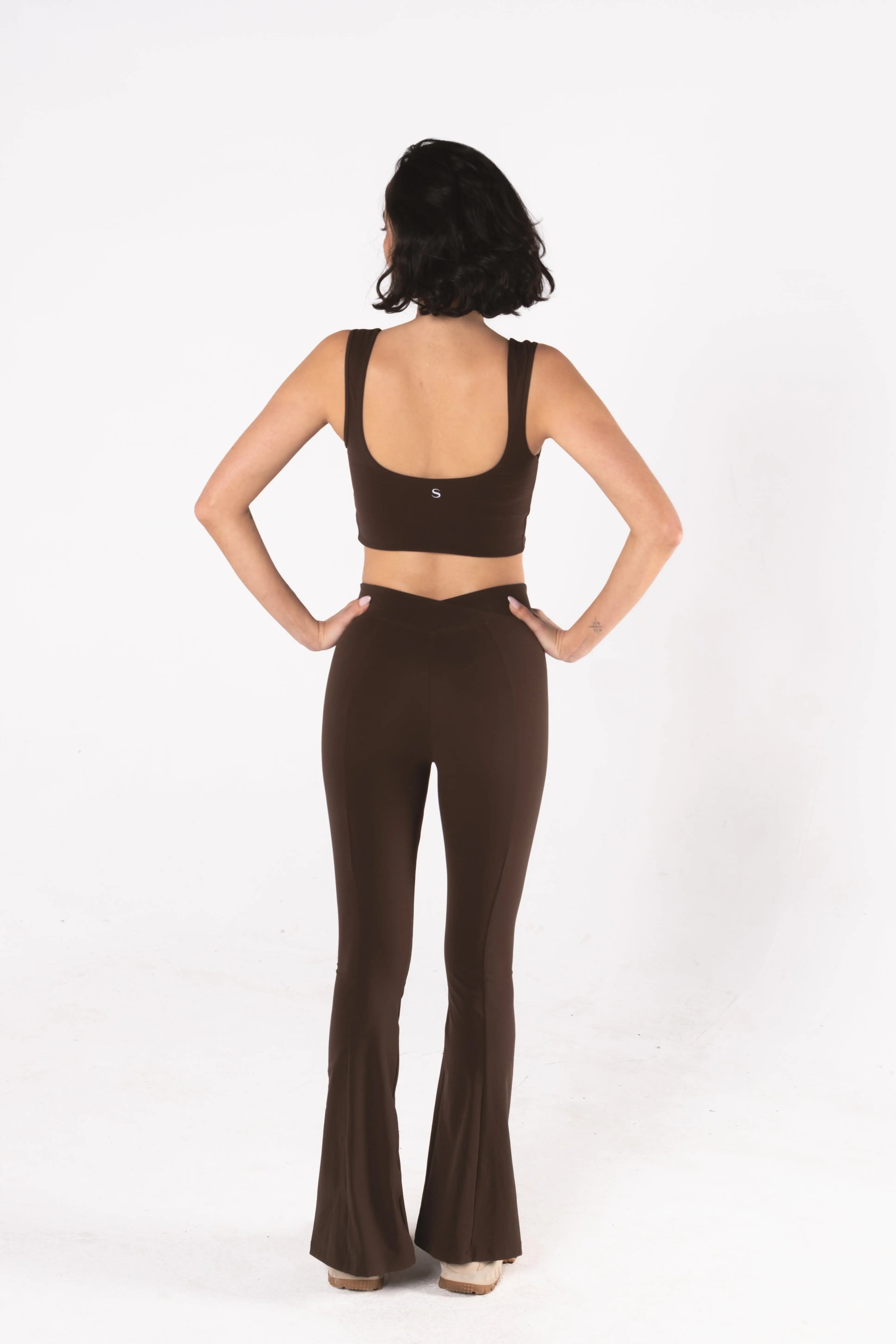 Woman wearing LESS Activewear Flow Sports Bra, designed for fuller busts