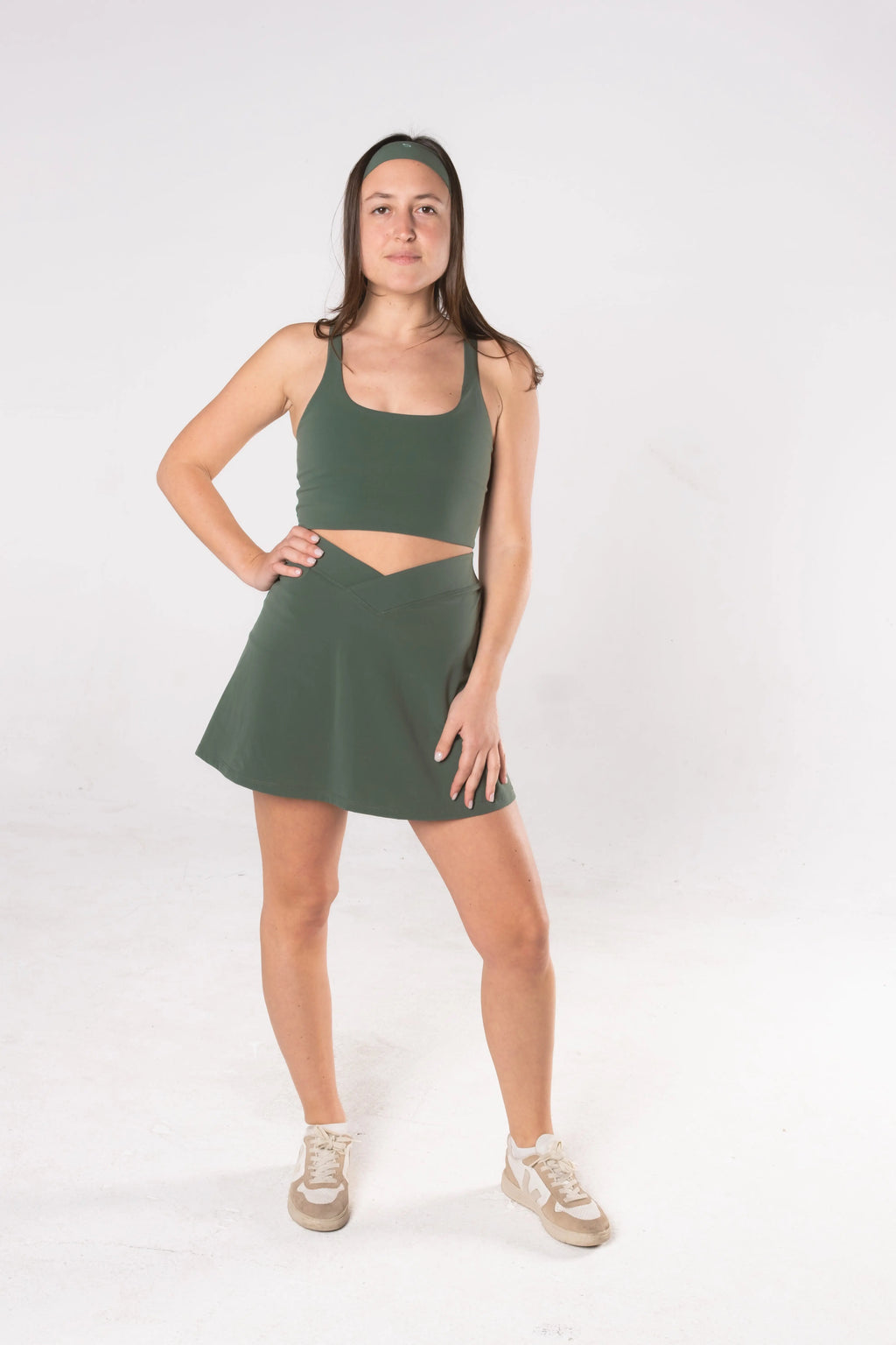Woman wearing LESS Activewear Cross Sports Bra, recommended for fuller busts