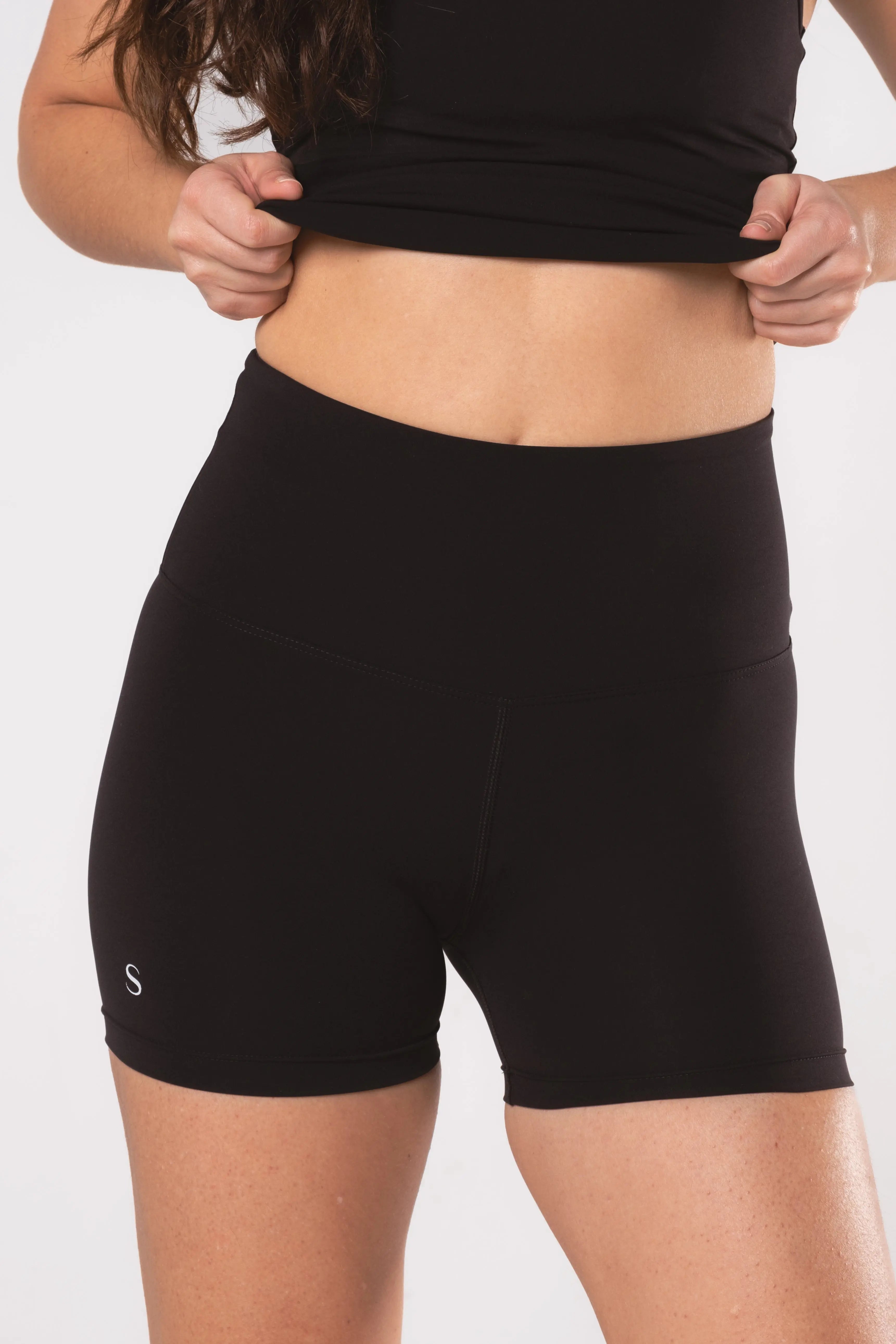 Woman wearing LESS Activewear Move Shorts, second skin fabric no waistband design