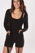 Woman wearing LESS Activewear Wrap Top, feminine coverage top for pilates