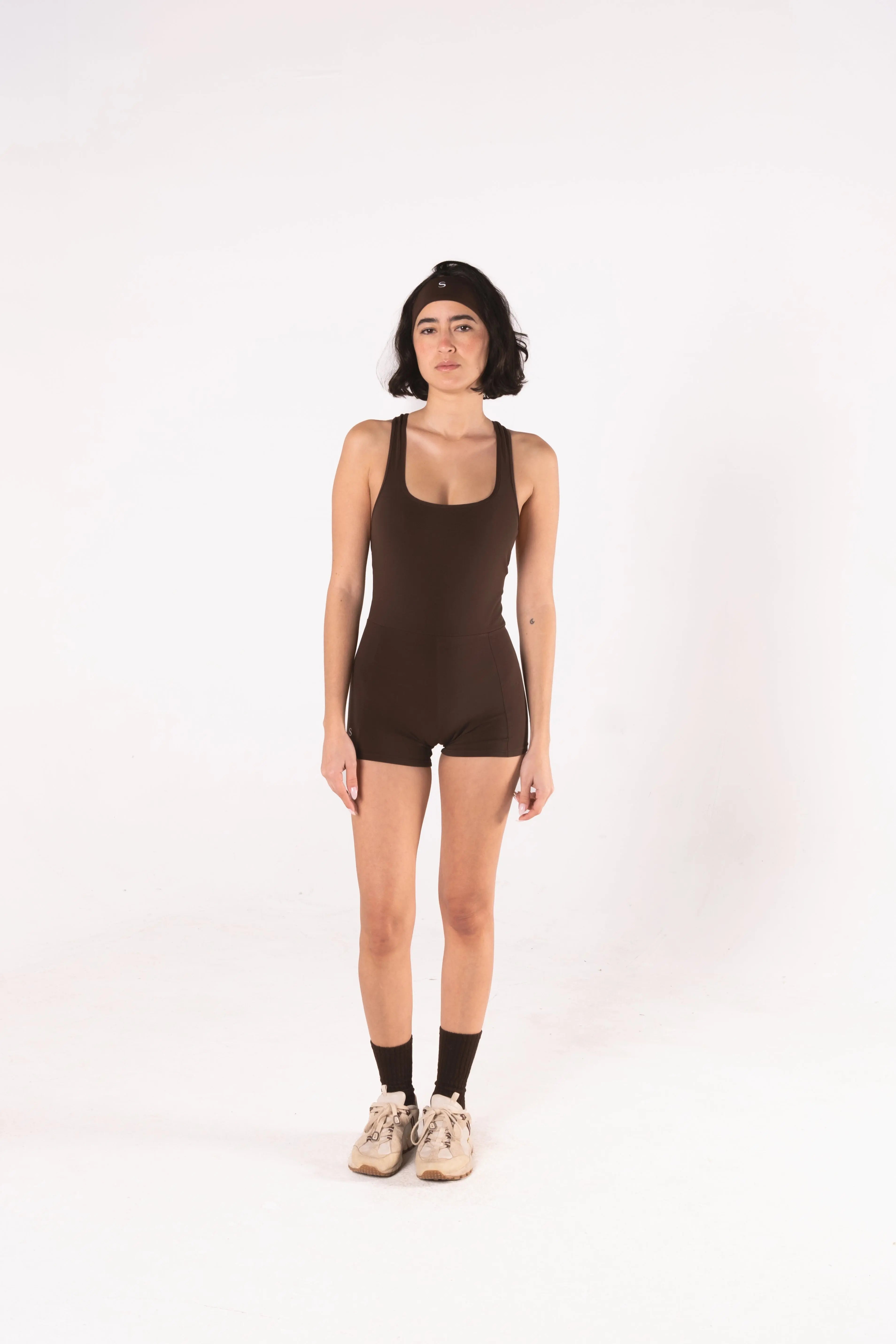 Woman wearing LESS Activewear Flex Short Jumpsuit, designed for hot yoga and hot pilates