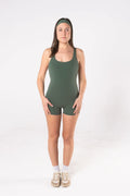 Woman wearing LESS Activewear Flex Short Jumpsuit, designed for hot yoga and hot pilates