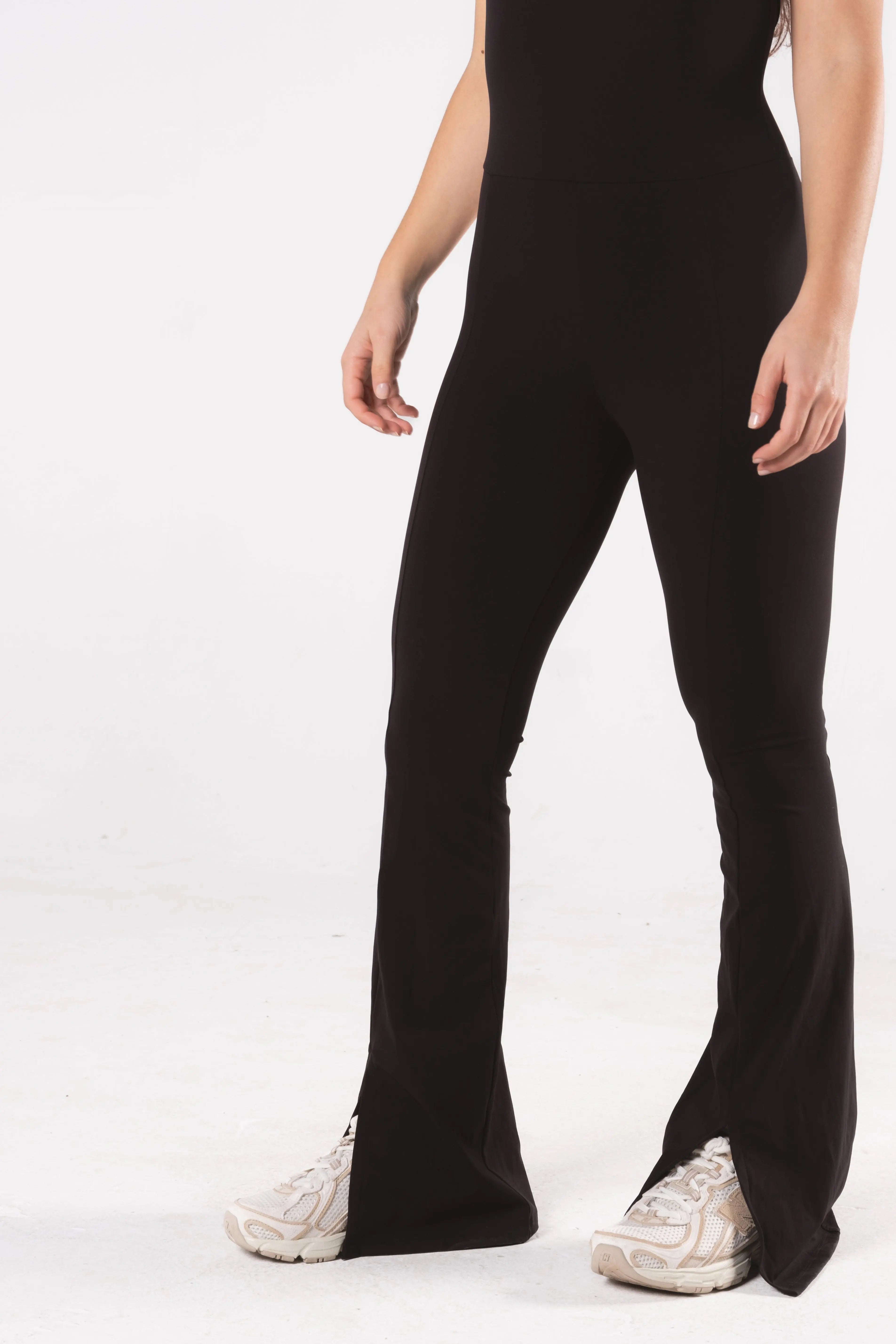 Woman wearing LESS Activewear Frame Long Jumpsuit, full-length minimalist one-piece