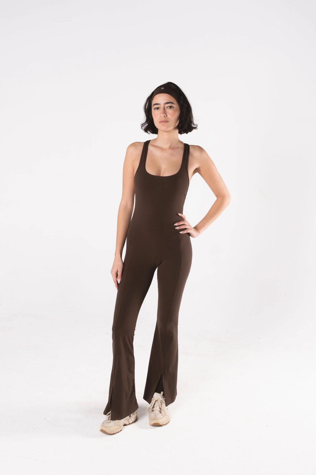 Woman wearing LESS Activewear Frame Long Jumpsuit, full-length minimalist one-piece