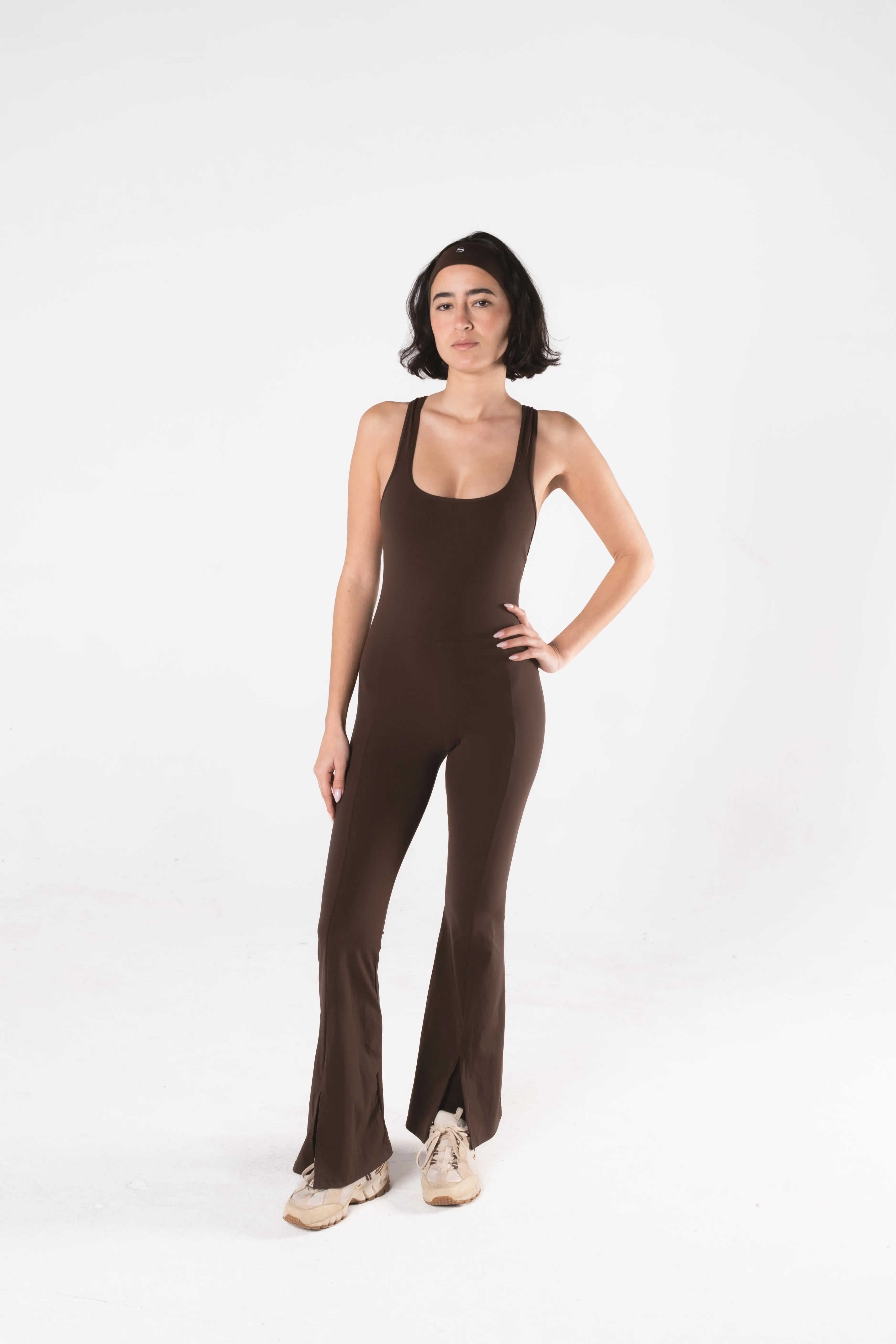 Woman wearing LESS Activewear Frame Long Jumpsuit, full-length minimalist one-piece