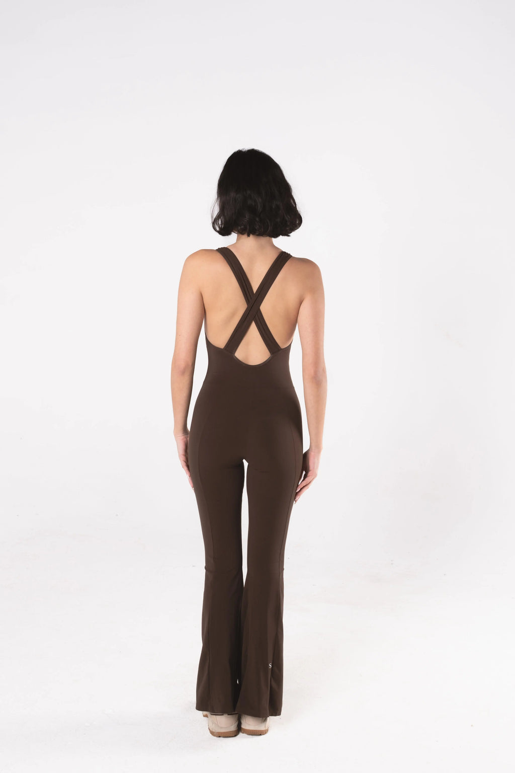 Woman wearing LESS Activewear Frame Long Jumpsuit, full-length minimalist one-piece