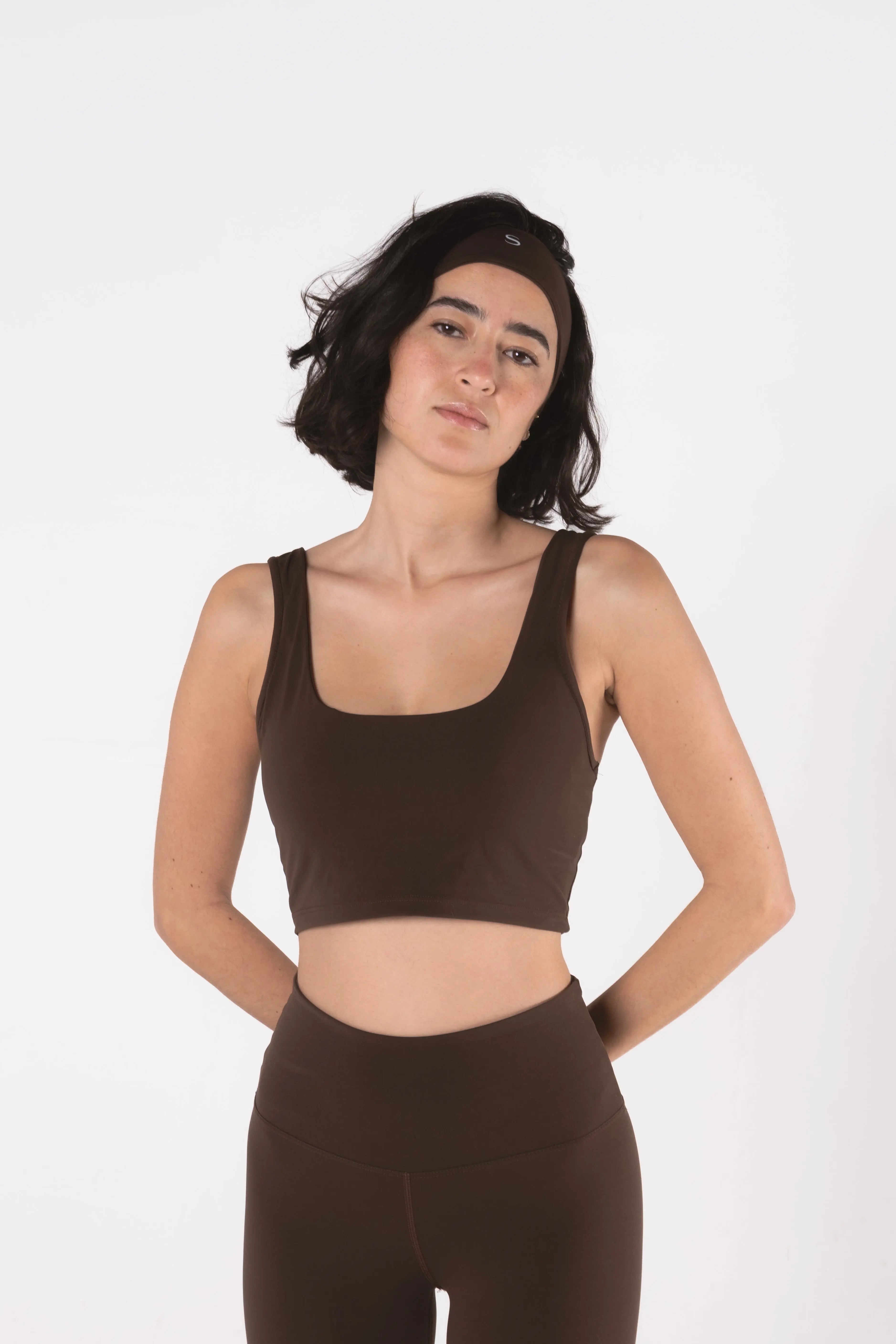 Woman wearing LESS Activewear Base 02 Crop Top, designed for medium busts