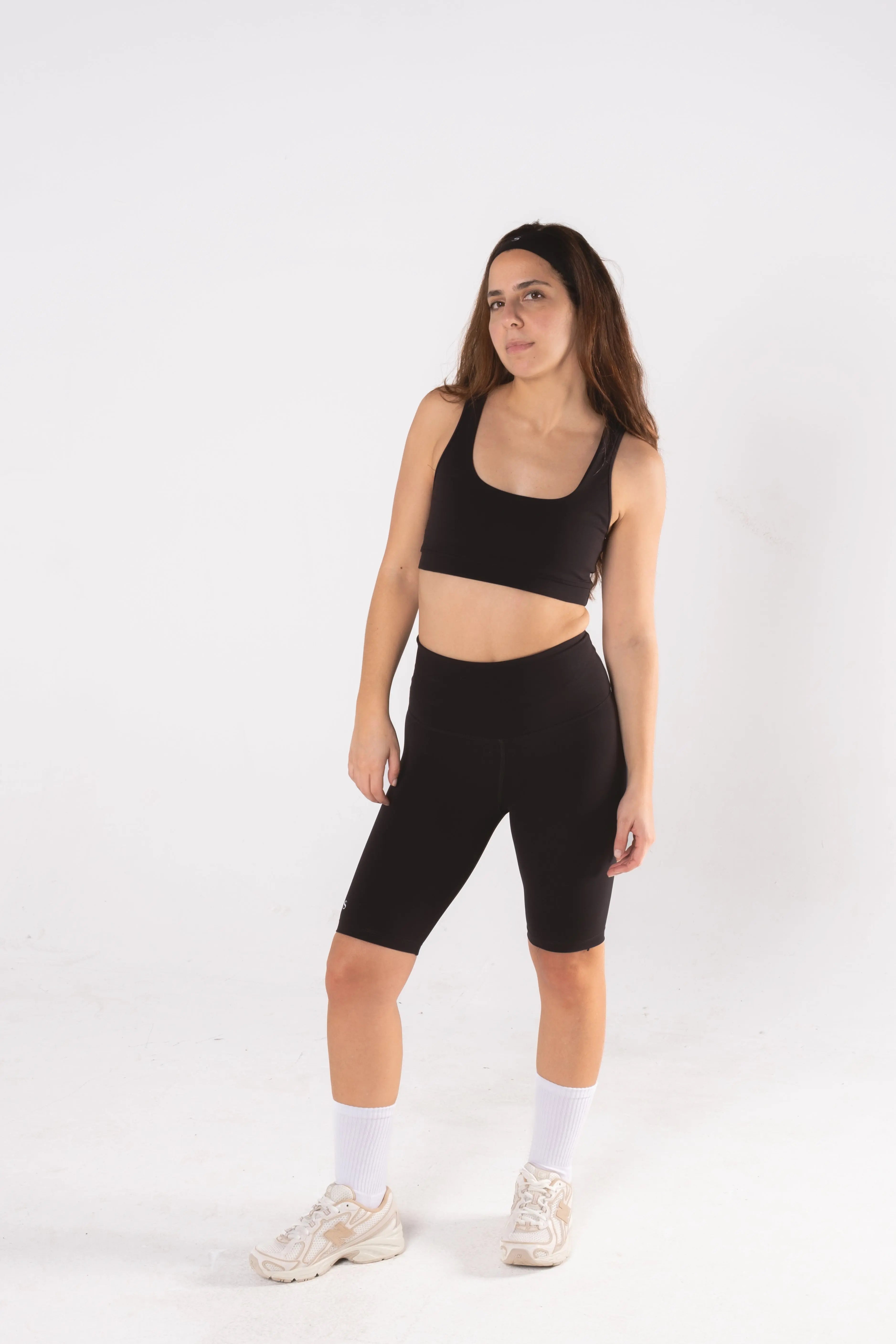 Woman wearing LESS Activewear Pace Cycling Shorts, second skin feel minimalist design