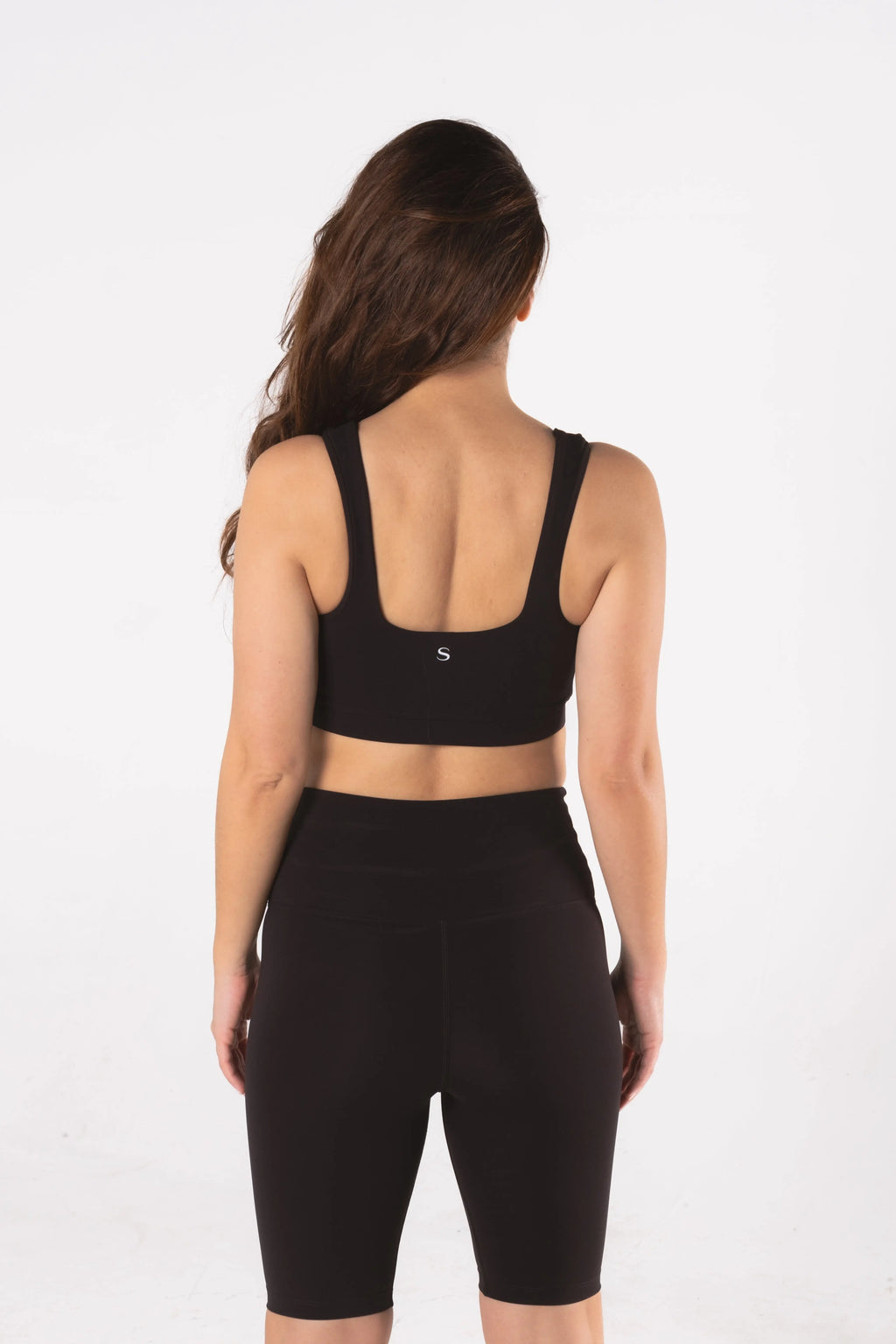 Woman wearing LESS Activewear Pace Cycling Shorts, second skin feel minimalist design