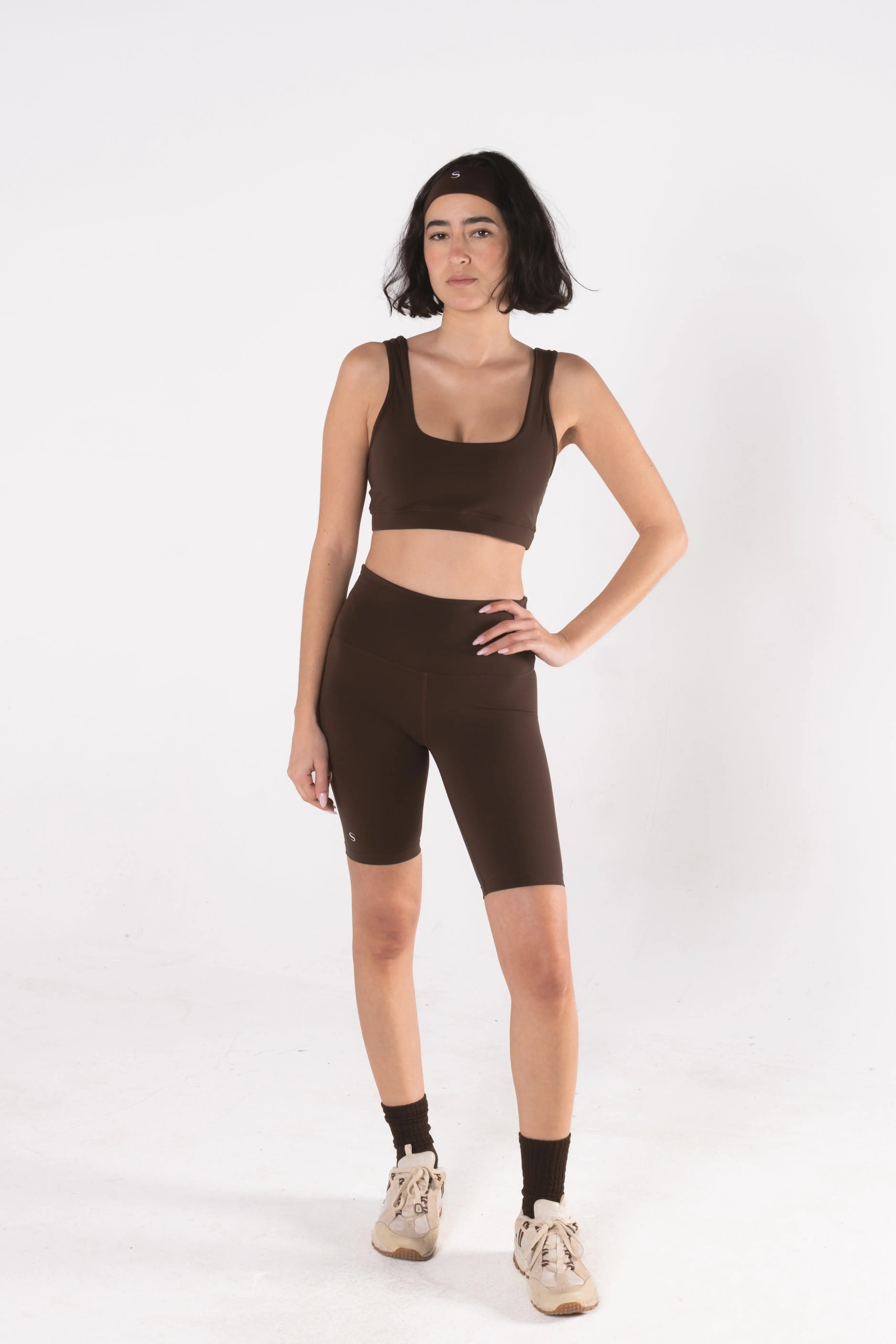 Woman wearing LESS Activewear Pace Cycling Shorts, second skin feel minimalist design
