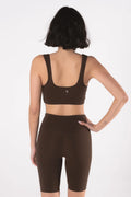 Woman wearing LESS Activewear Pace Cycling Shorts, second skin feel minimalist design