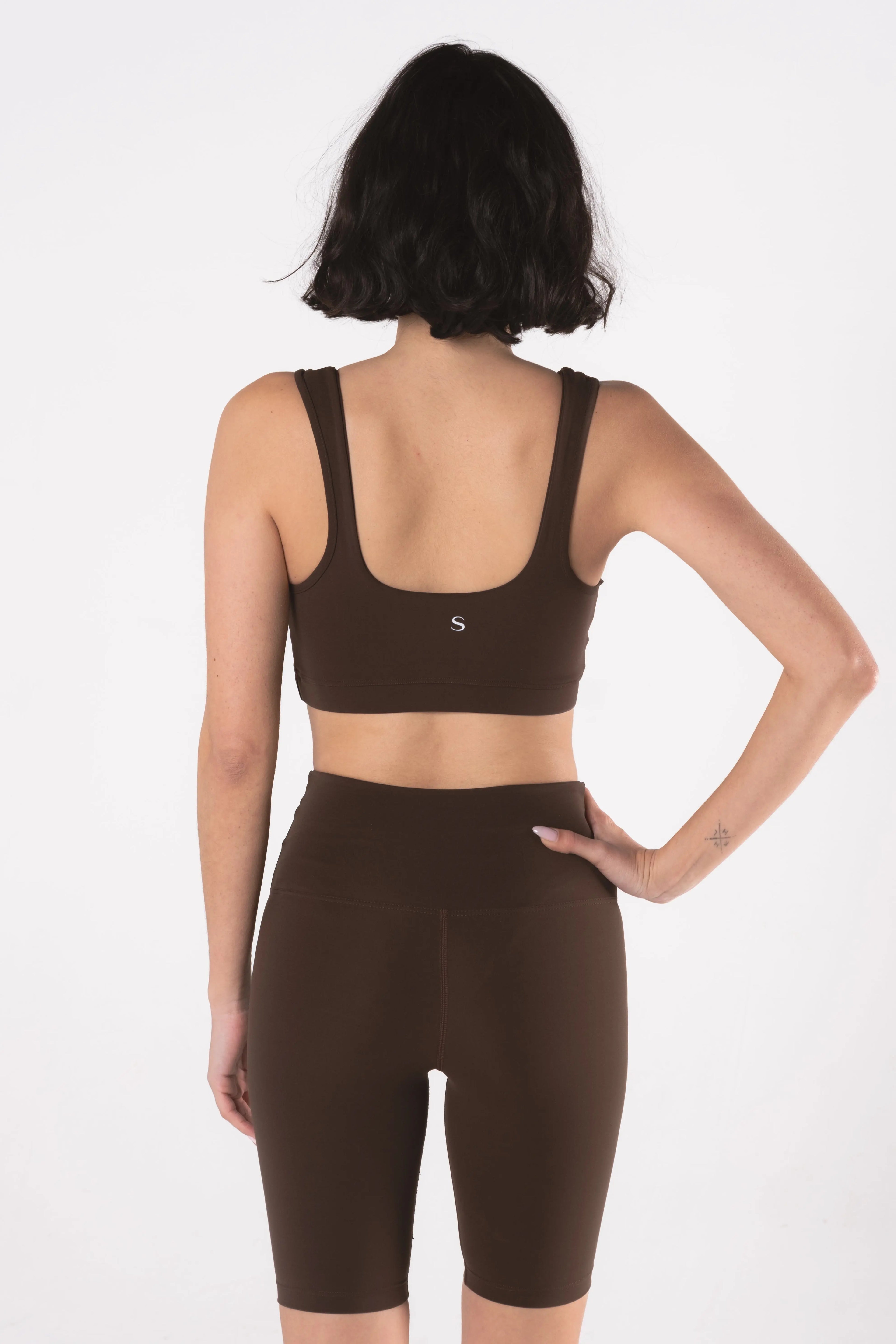 Woman wearing LESS Activewear Pace Cycling Shorts, second skin feel minimalist design