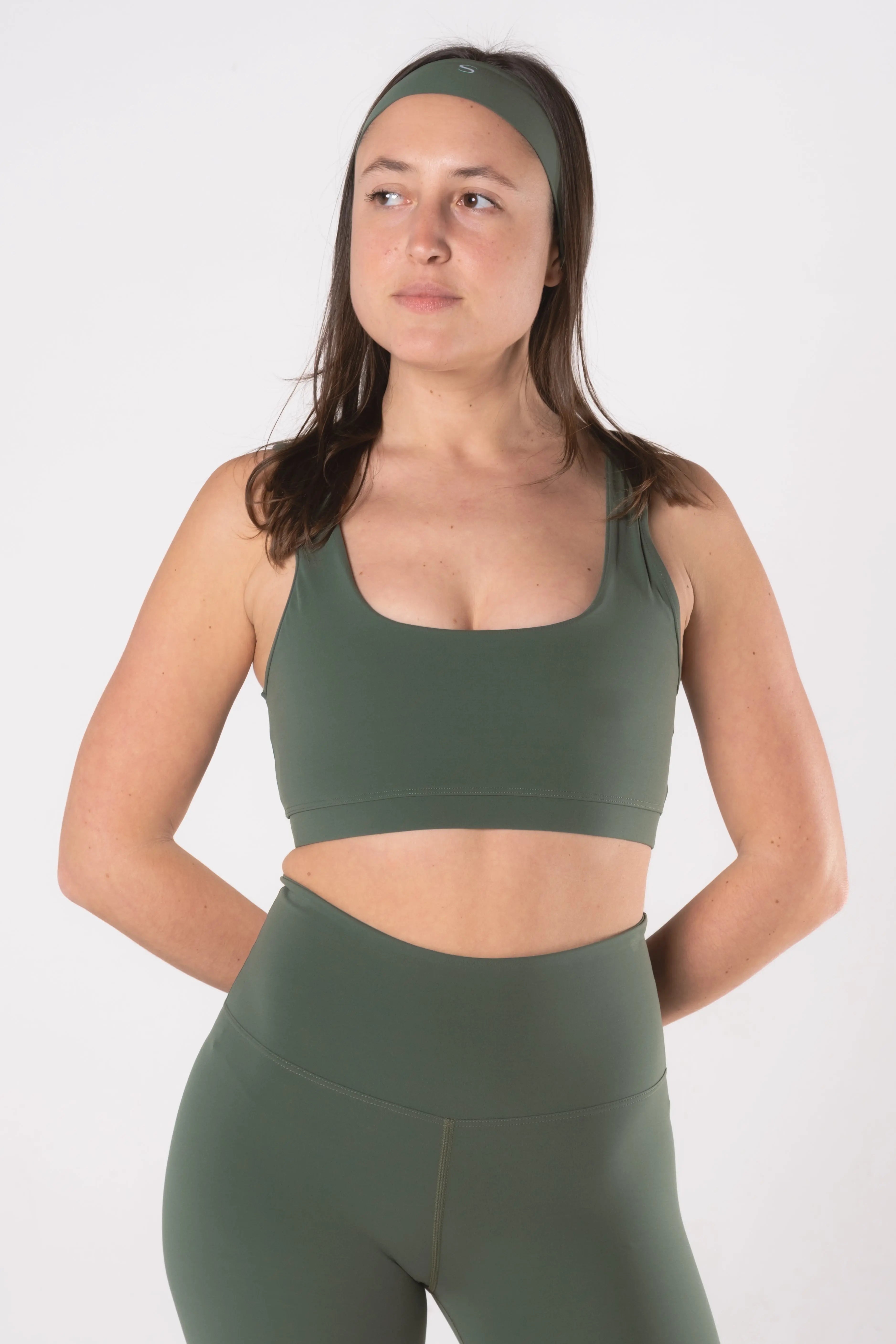 Woman wearing LESS Activewear minimalist headband during workout, clean slim design
