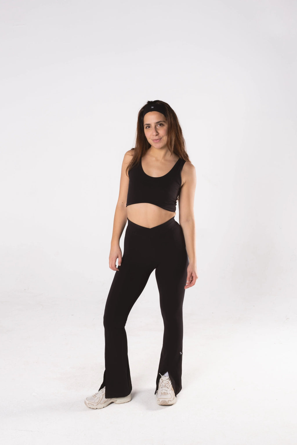Woman wearing LESS Activewear Flow Sports Bra, designed for fuller busts