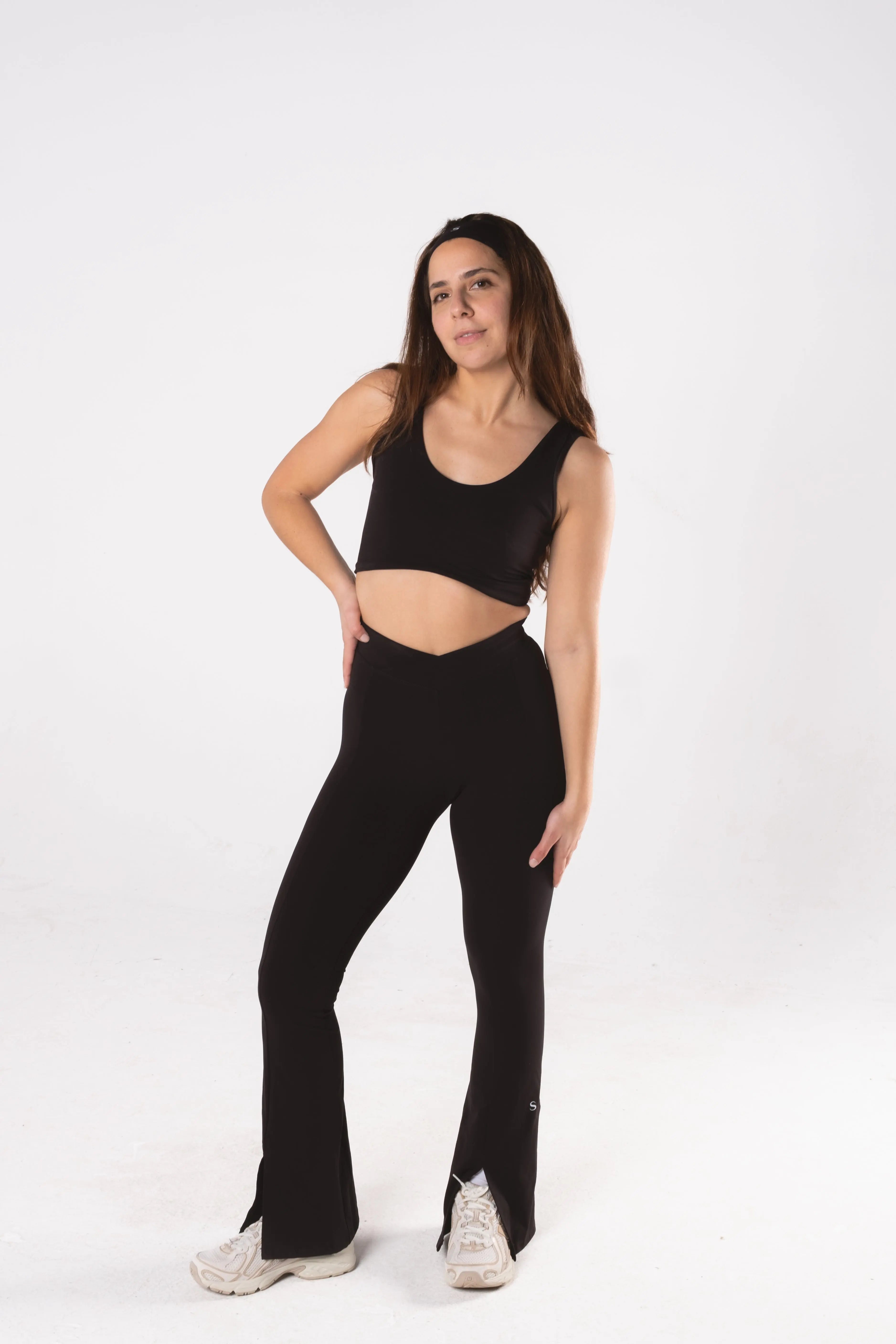 Woman wearing LESS Activewear Flow Sports Bra, designed for fuller busts