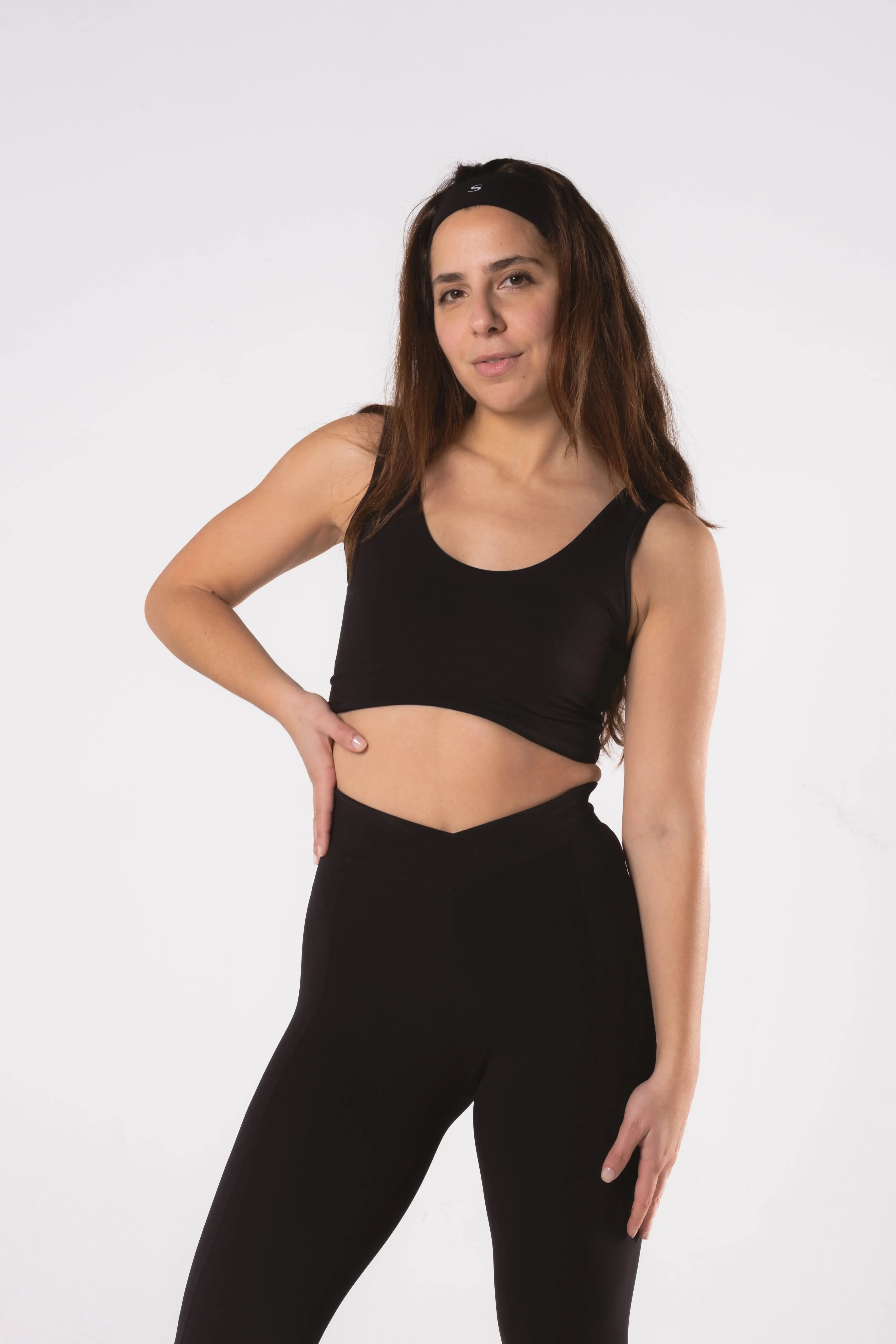 Woman wearing LESS Activewear Flow Sports Bra, designed for fuller busts