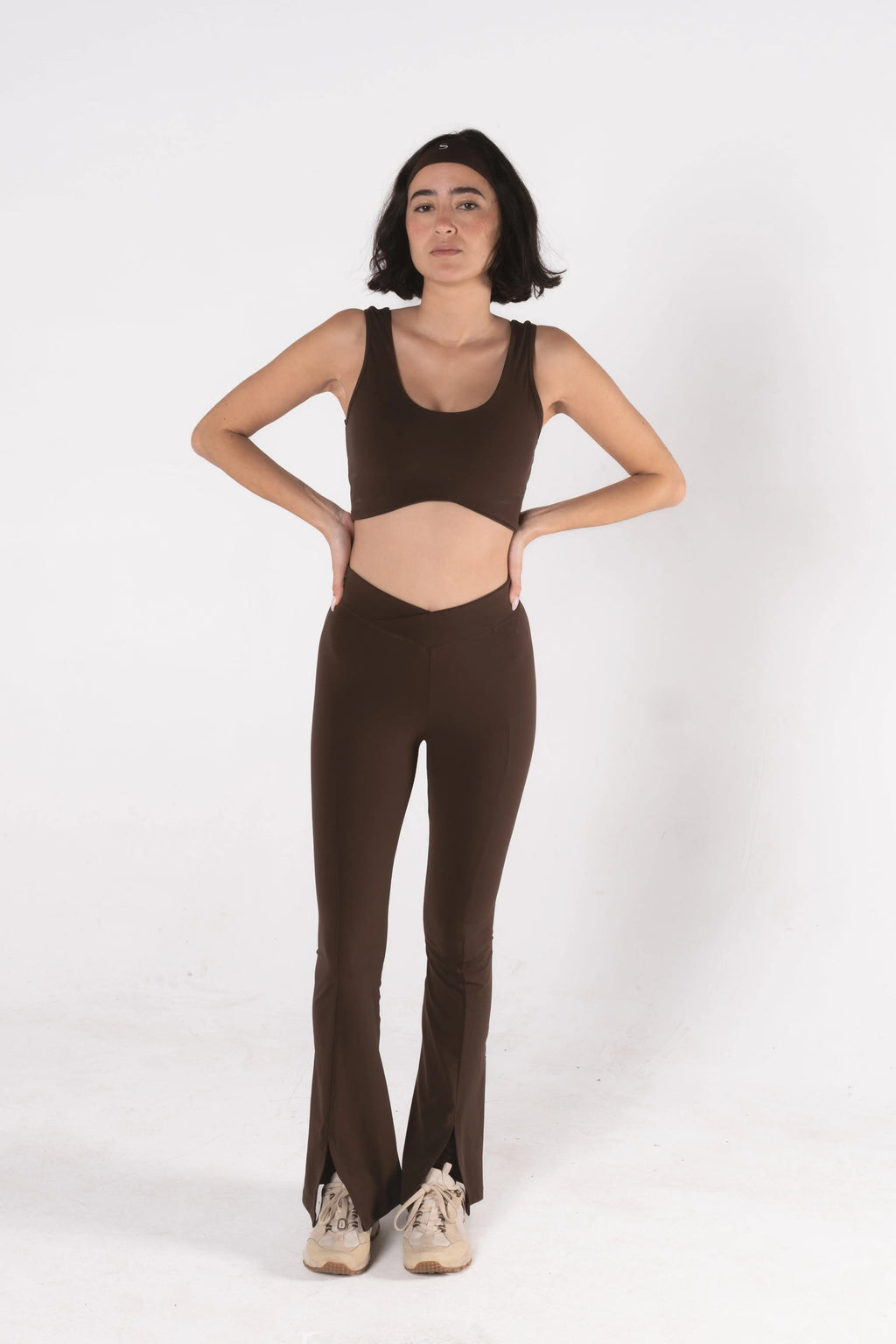Woman wearing LESS Activewear Flow Sports Bra, designed for fuller busts
