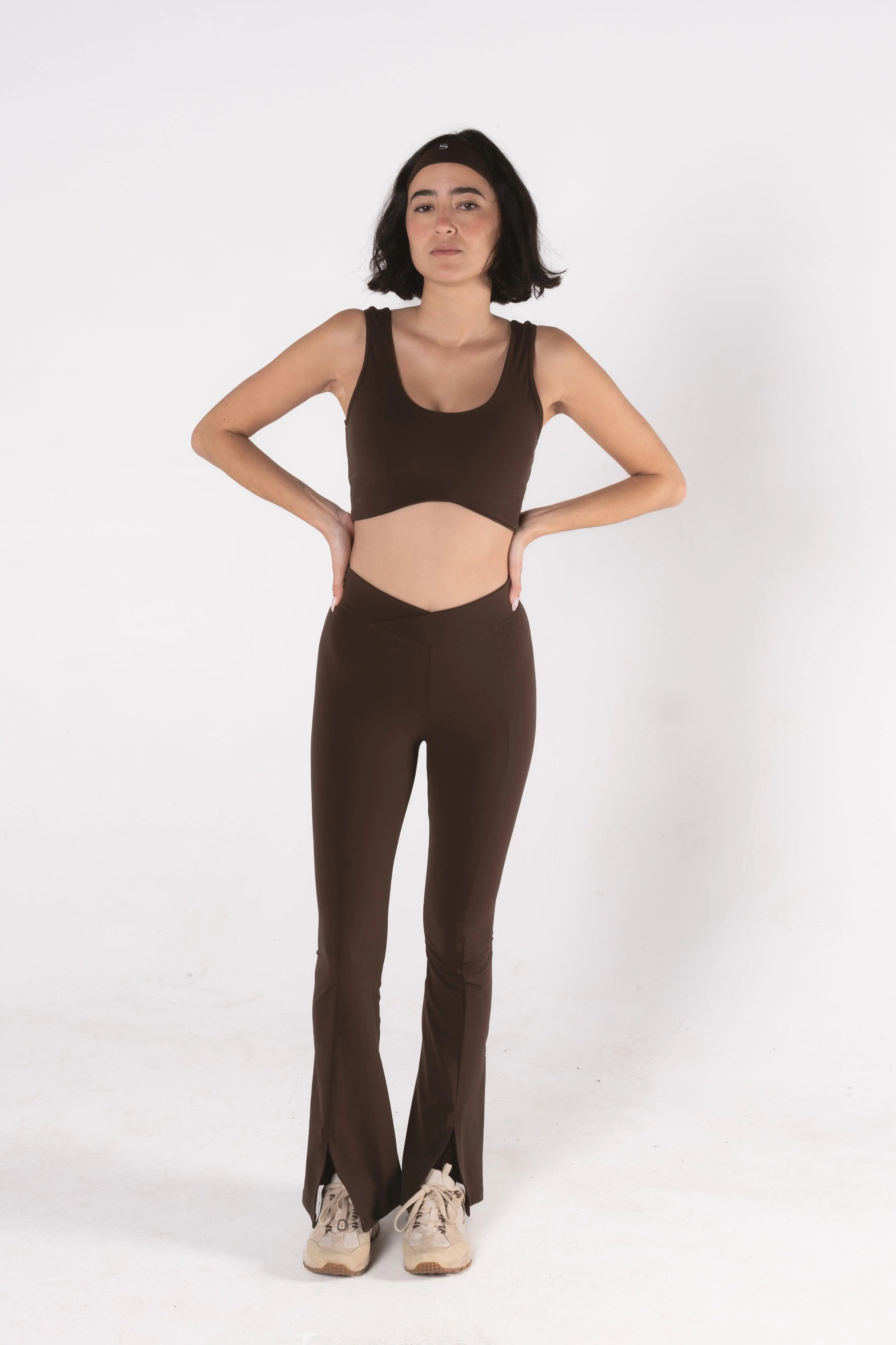 Woman wearing LESS Activewear Flow Sports Bra, designed for fuller busts