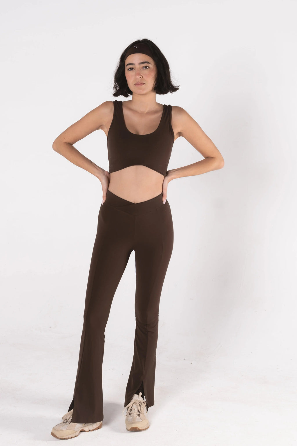 Woman wearing LESS Activewear Flow Sports Bra, designed for fuller busts